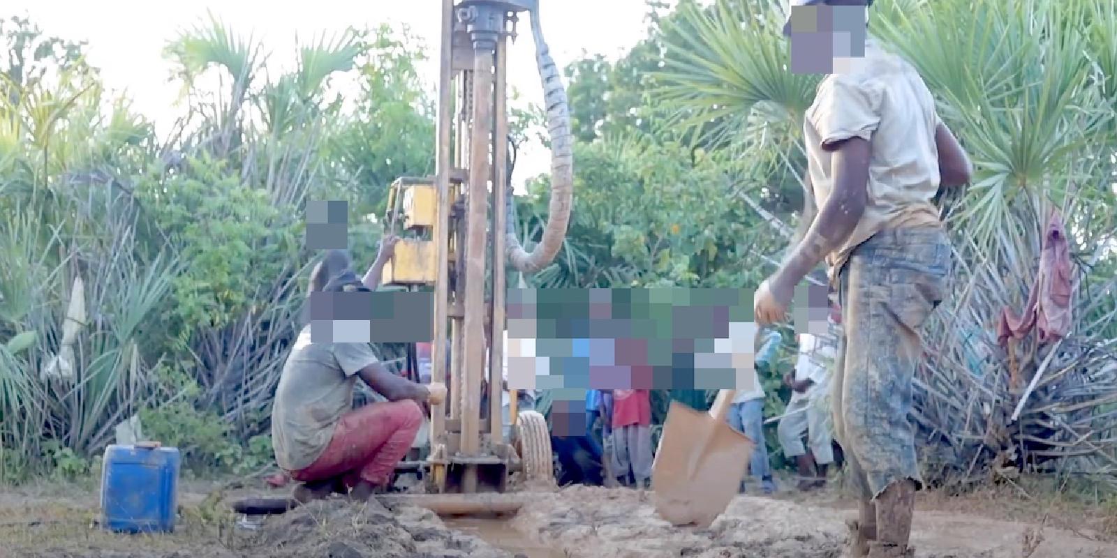 Contractors use a drilling rig to bore for water